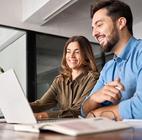 A Private School Financial Aid Director working with a colleague on a computer