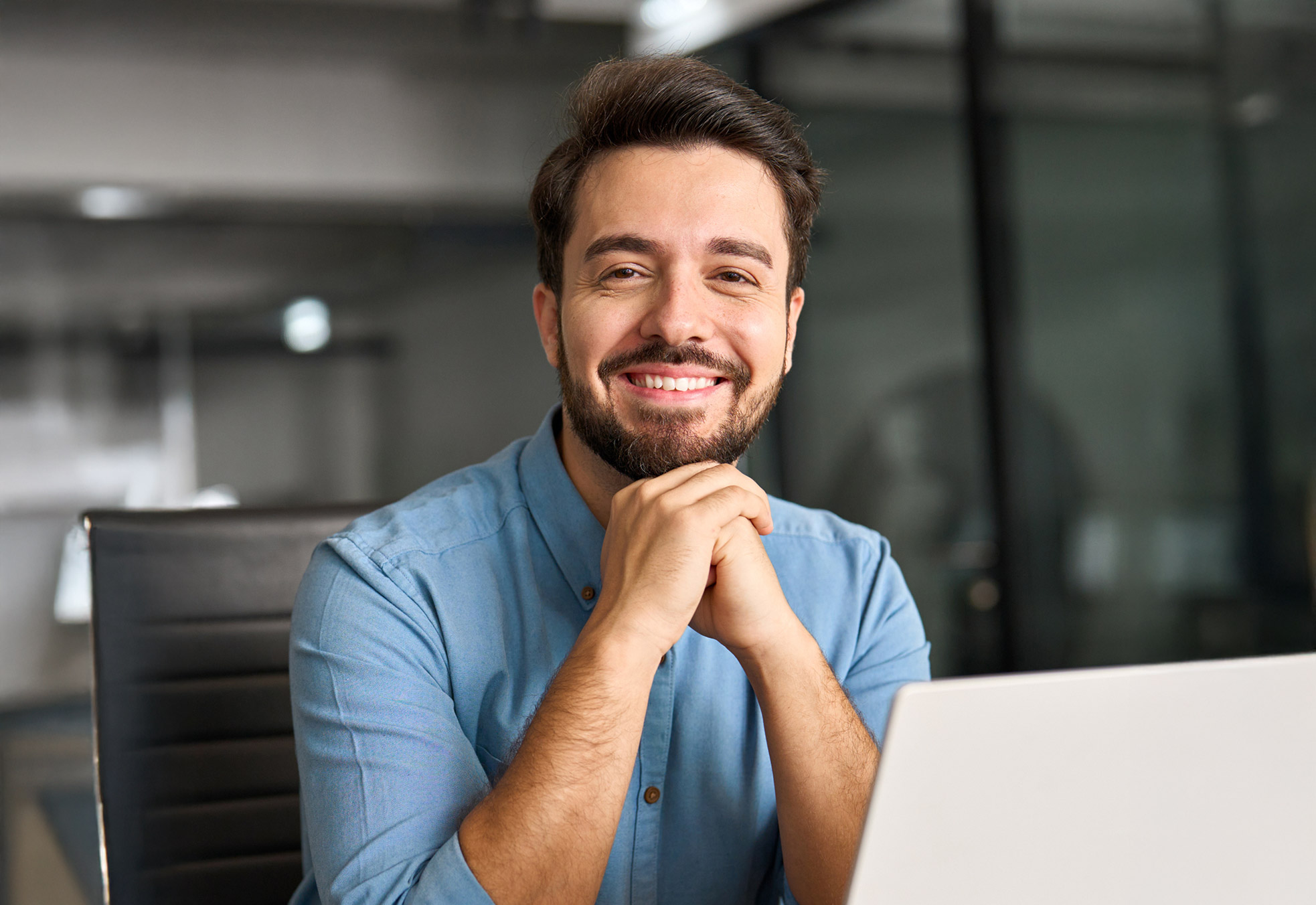 A smiling Private School Financial Aid Director working on his computer