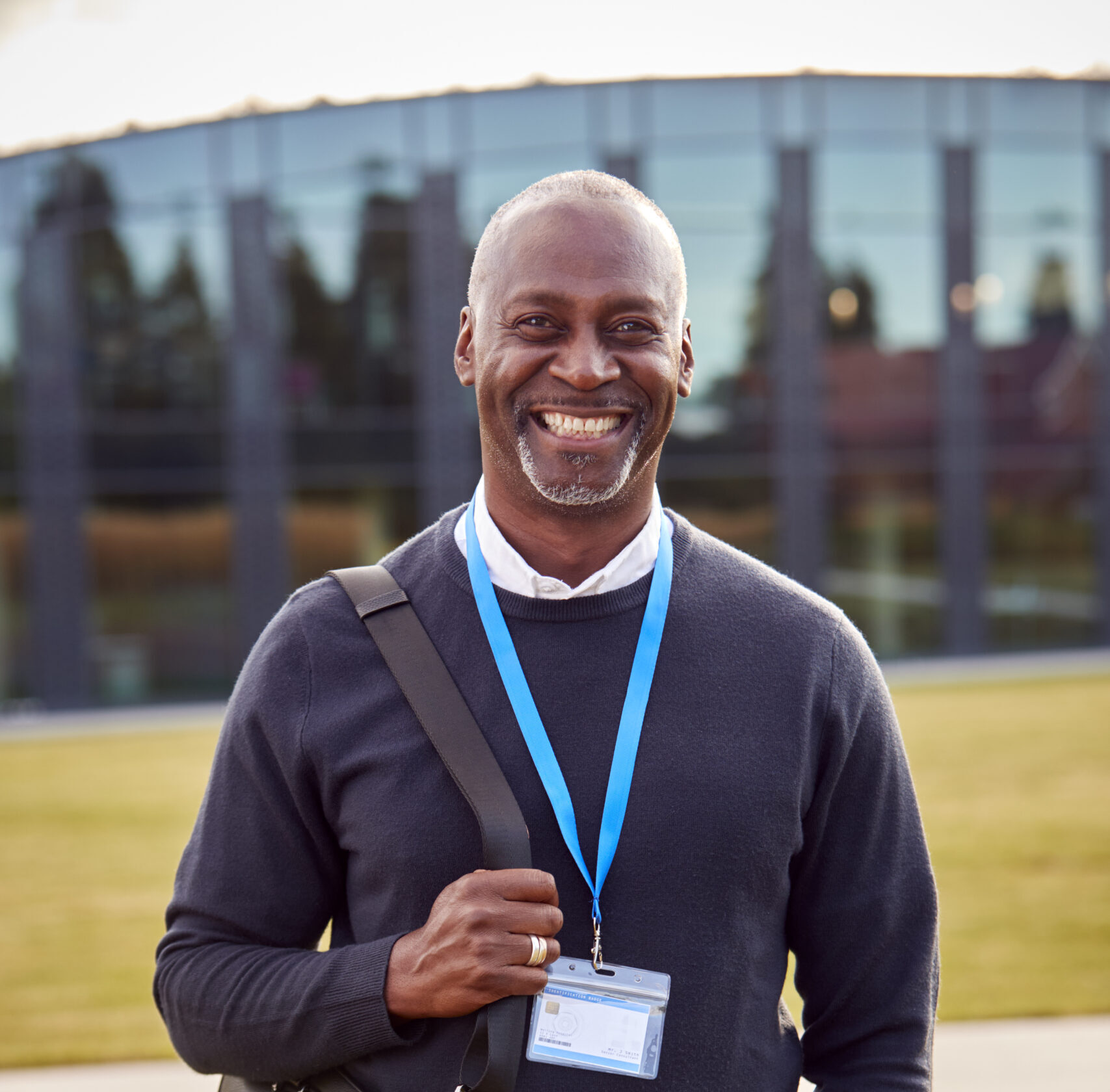 Financial aid director smiling outside of a private school