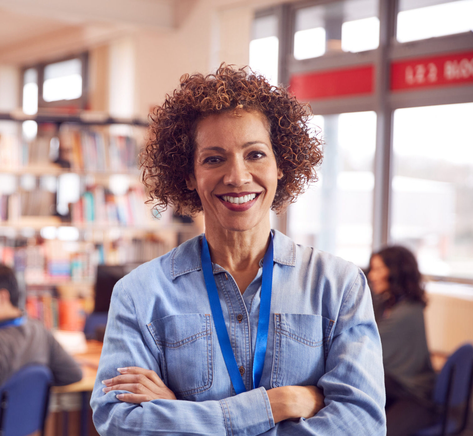 A teacher smiling in a library