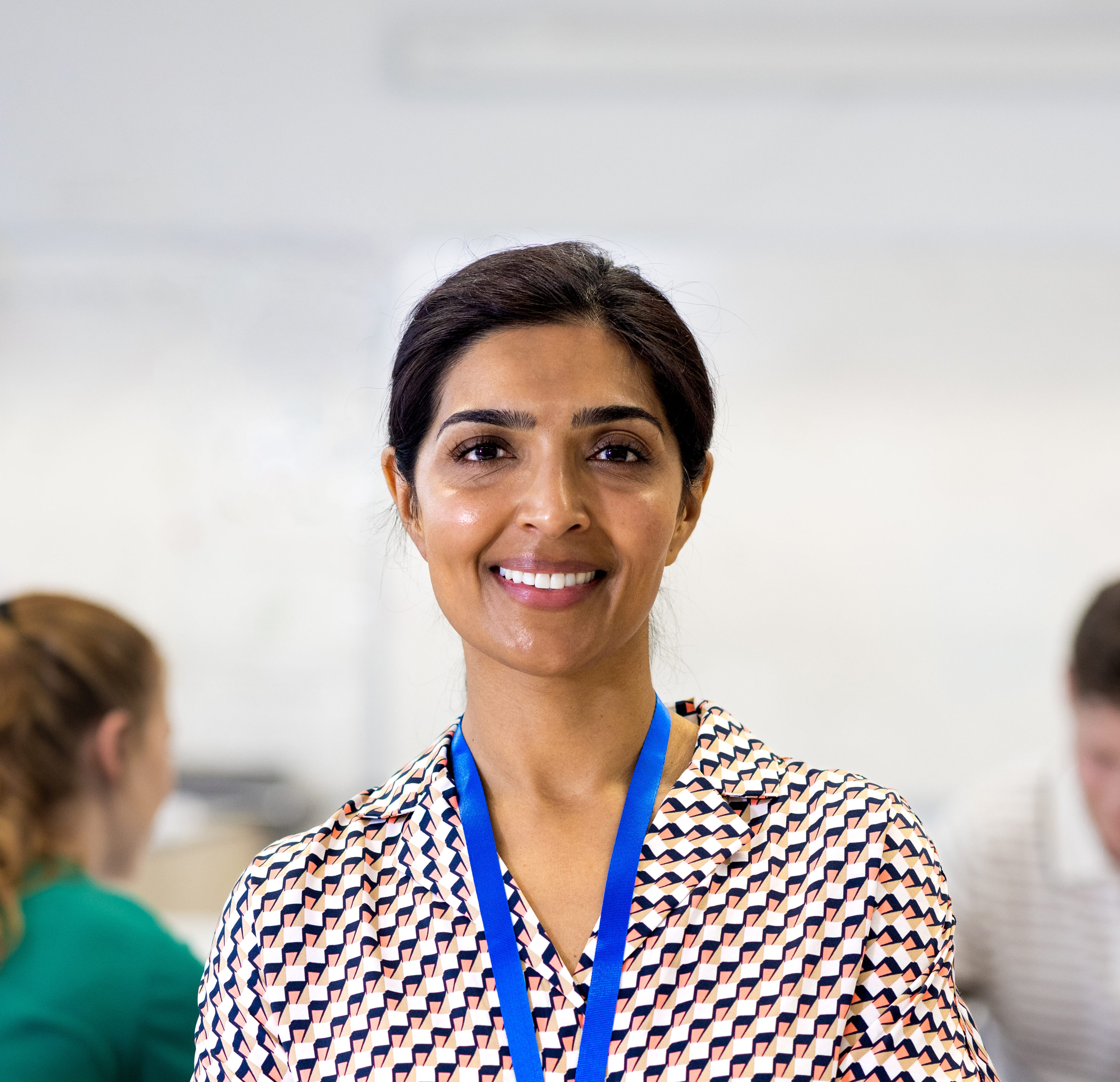 An Admissions Director smiling in a private school classroom