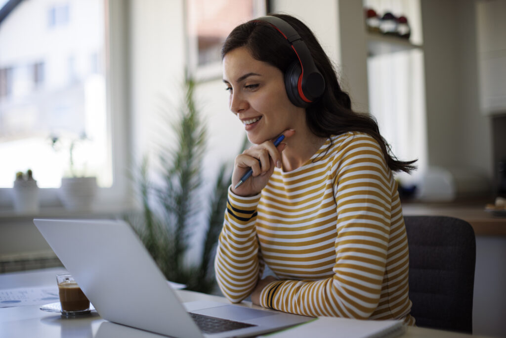 A woman tuning in to the Ravenna Enrollment Trends Webinar