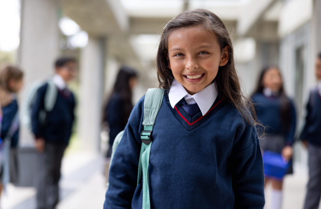 Girl smiling while coming to school for early admissions